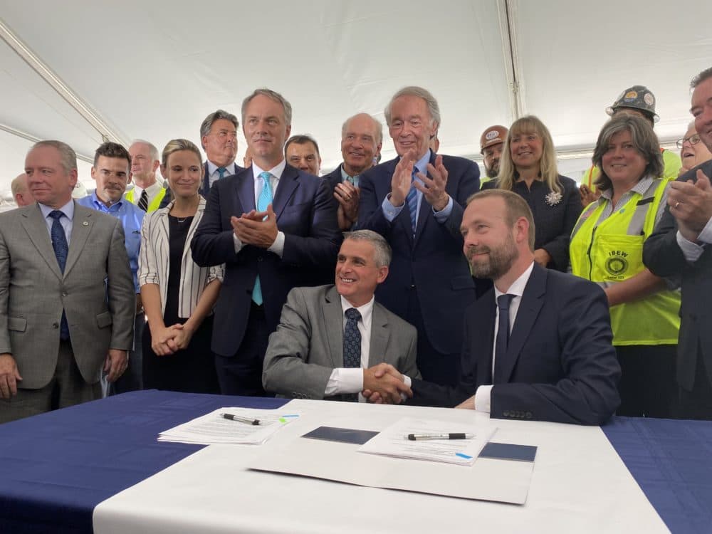 Southeastern Mass. Building Trades Council President David Araujo (left) shakes hands with Vineyard Wind CEO Lars Pedersen after signing a project labor agreement at the New Bedford Marine Commerce Terminal, July 16, 2021. Miriam Wasser, WBUR