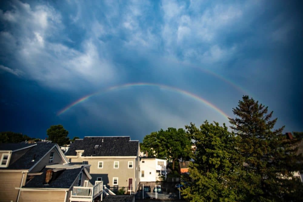 What was almost a double rainbow was seen over East Somerville on Wednesday evening, after afternoon storms. More rain is expected Thursday and into the holiday weekend. (Jesse Costa/WBUR)
