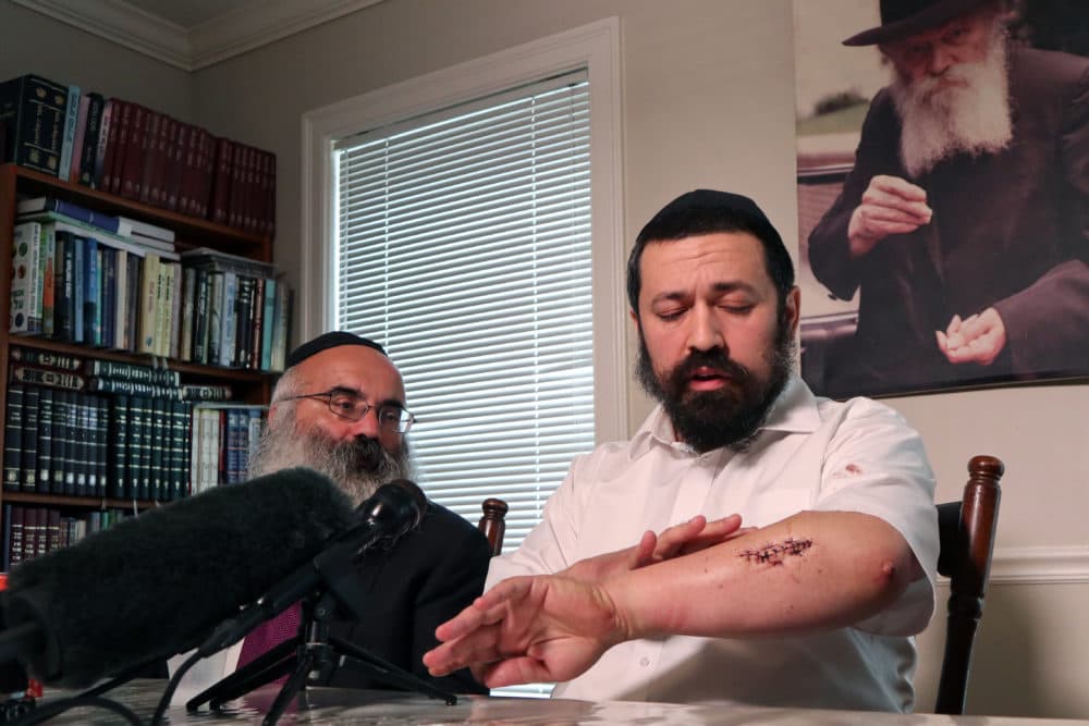 Rabbi Shlomo Noginski, right, sits with Rabbi Dan Rodkin in his Brighton home on Sunday. (Adrian Ma/WBUR)