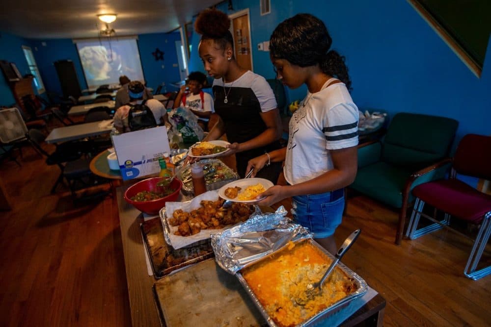 A hot meal of fried chicken, macaroni and cheese and salad is prepared for campers to enjoy while they are at the camp. (Jesse Cota/WBUR)