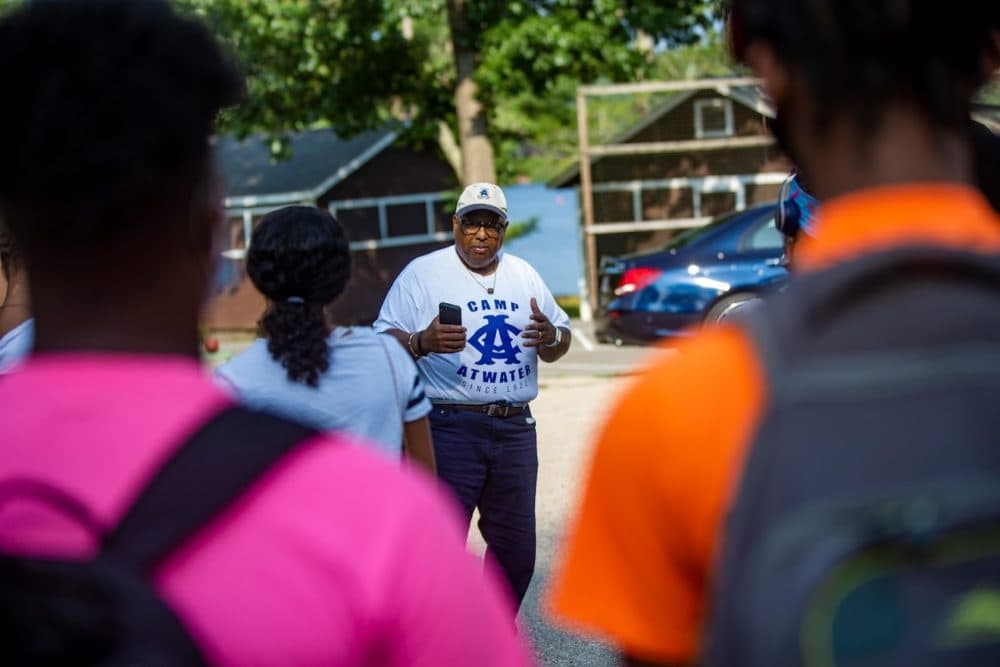 After campers arrive from Sprinfield by bus, Ubaan League of Springfield President Henry Thomas gives the words of encouragement to do anything they wish and to enjoy themselves while they are at Capm Atwater. (Jesse Costa/WBUR)