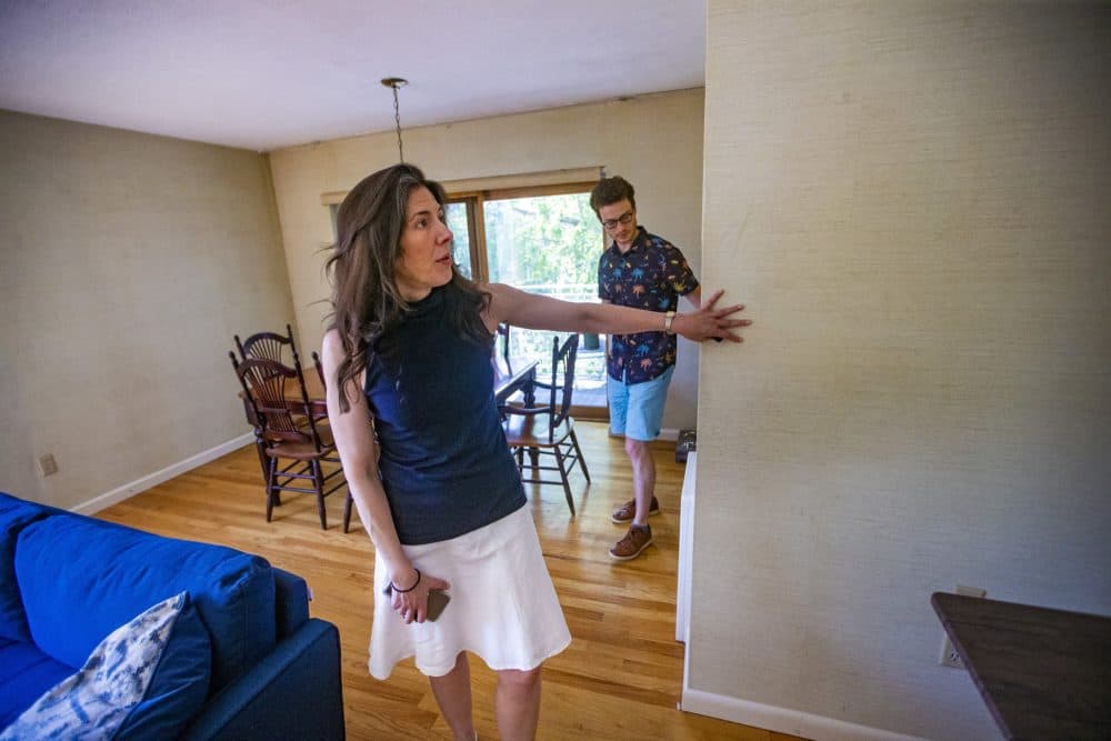 Real estate agent Lourdes Hernandez shows Leon Vasershteyn around a condominium for sale in Brookline. (Jesse Costa/WBUR)
