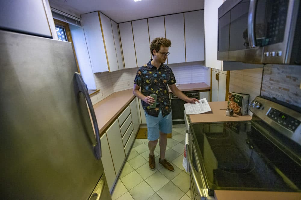 Leon Vasershteyn looks around the kitchen of a condominium for sale in Brookline. (Jesse Costa/WBUR)