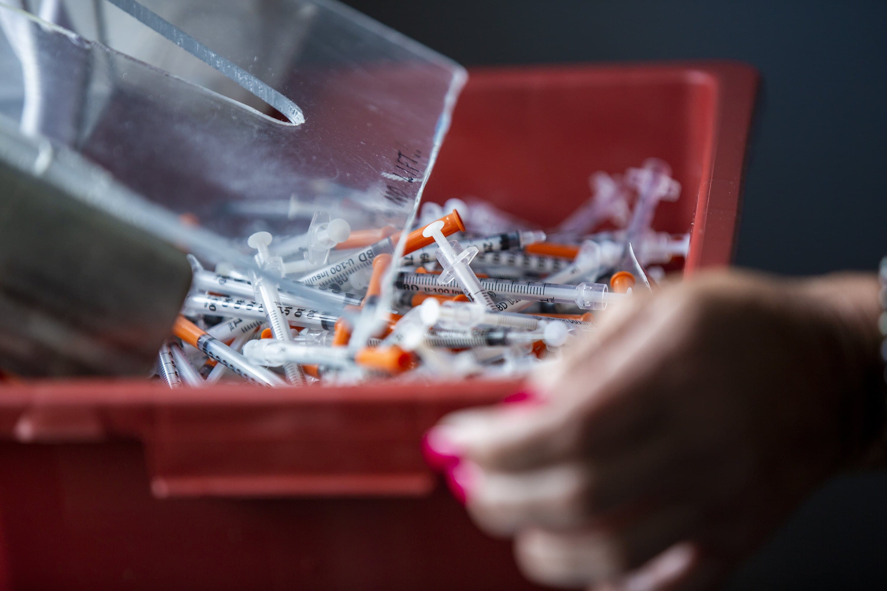 A container filled with close to 2,000 used syringes collected in a single morning at the Southampton Street Shelter in Boston. (Jesse Costa/WBUR)
