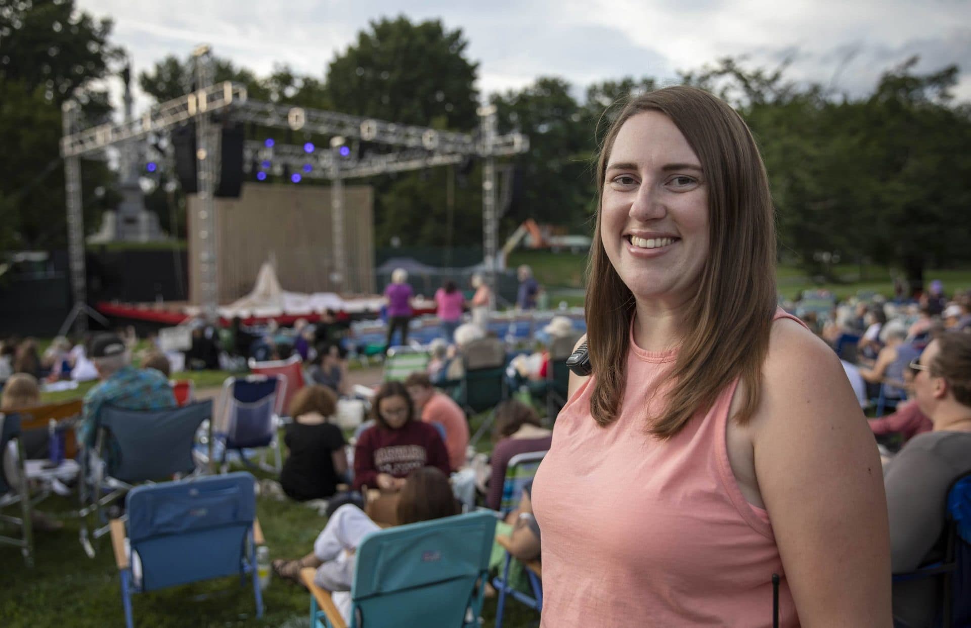 Jenna Worden, production manager of the Commonwealth Shakespeare Company's &quot;The Tempest,&quot; near the stage on Boston Common as the audience starts to arrive. (Robin Lubbock/WBUR)