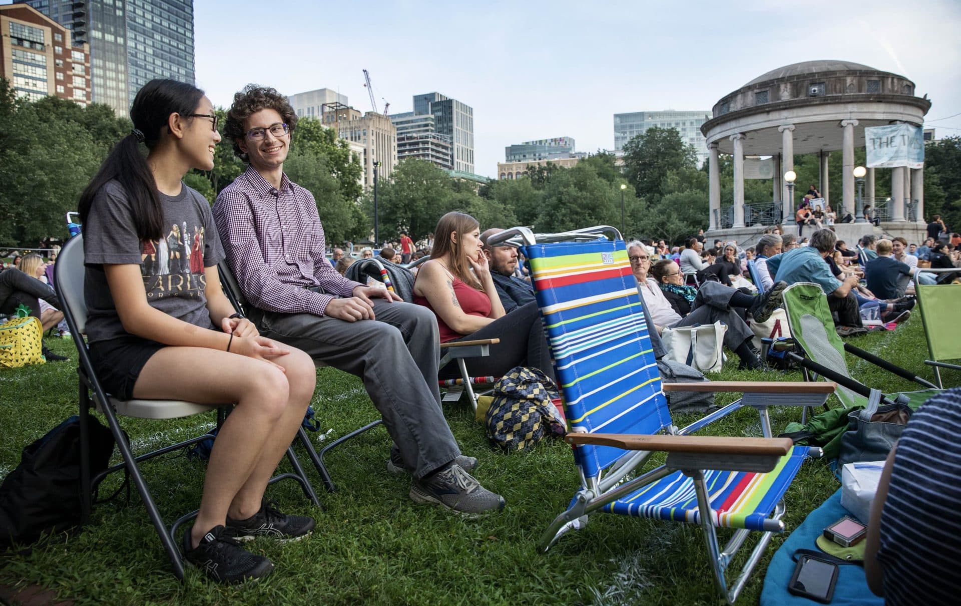 As evening falls, Northeastern students Sam Wohlever and Amanda Dee wait for the start of the &quot;The Tempest&quot; on Boston Common. (Robin Lubbock/WBUR)