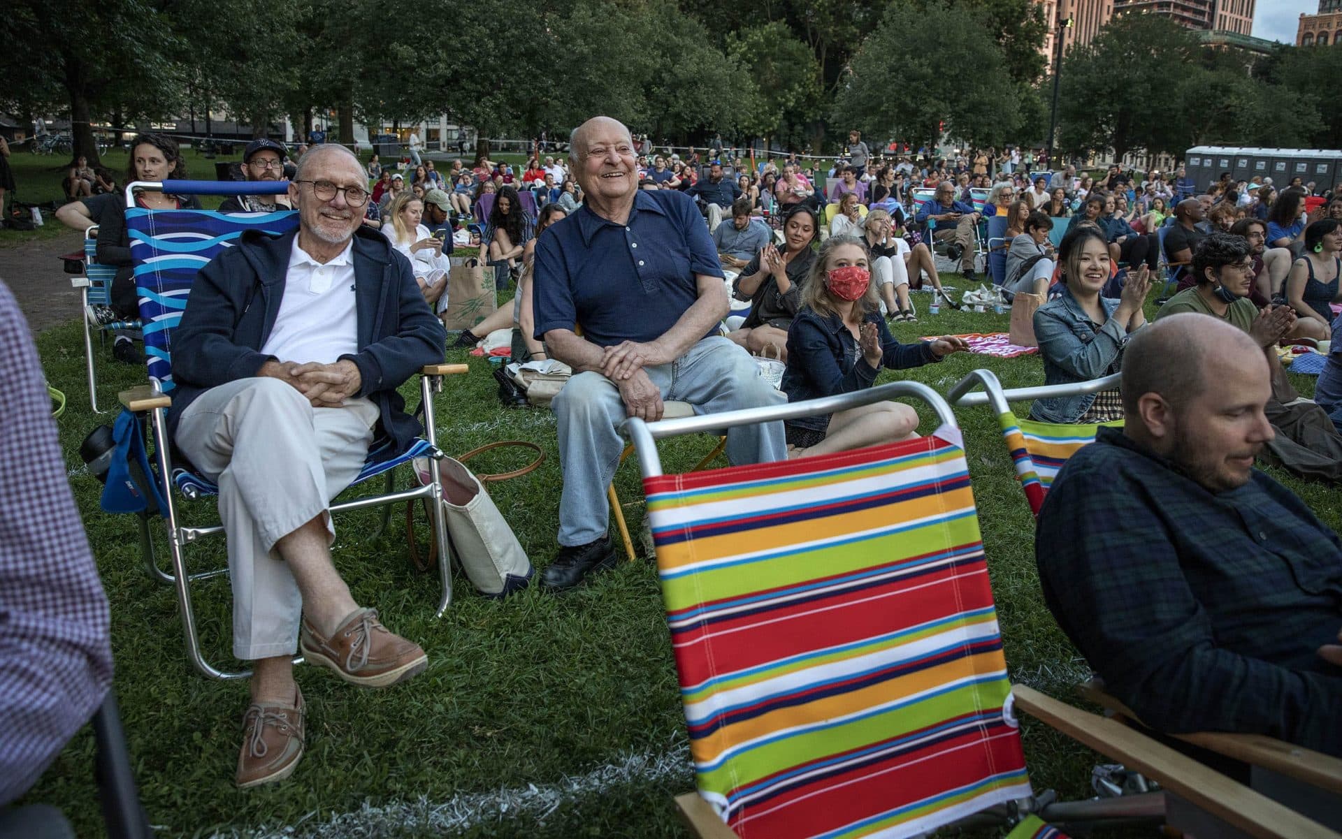 Stanley Sayer and Craig Pierce wait for the start of the performance of &quot;The Tempest&quot; on Boston Common. (Robin Lubbock/WBUR)