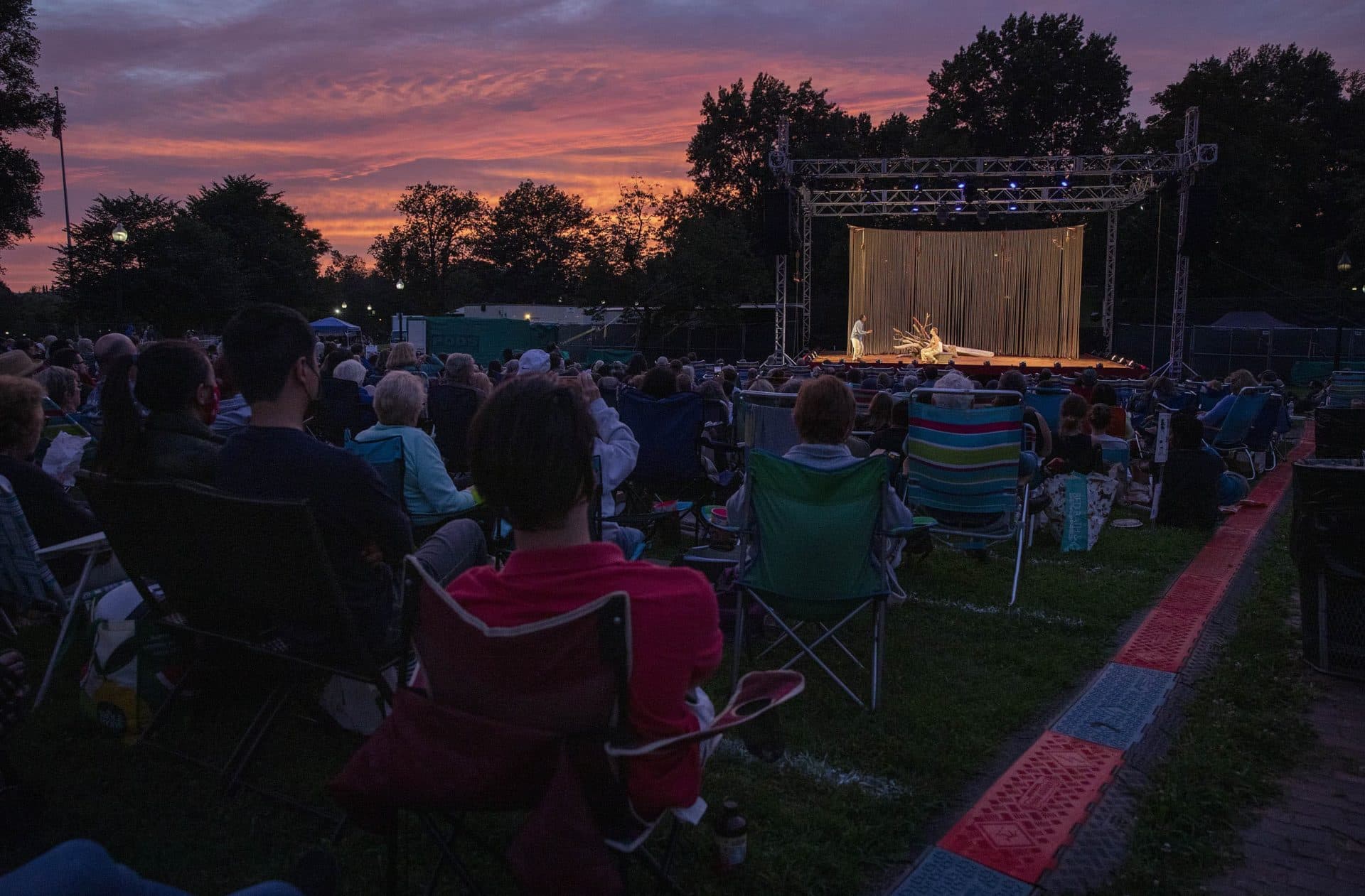 Sitting on deck chairs and blankets, the audience watches the Commonwealth Shakespeare Company's performance of &quot;The Tempest.&quot; (Robin Lubbock/WBUR)