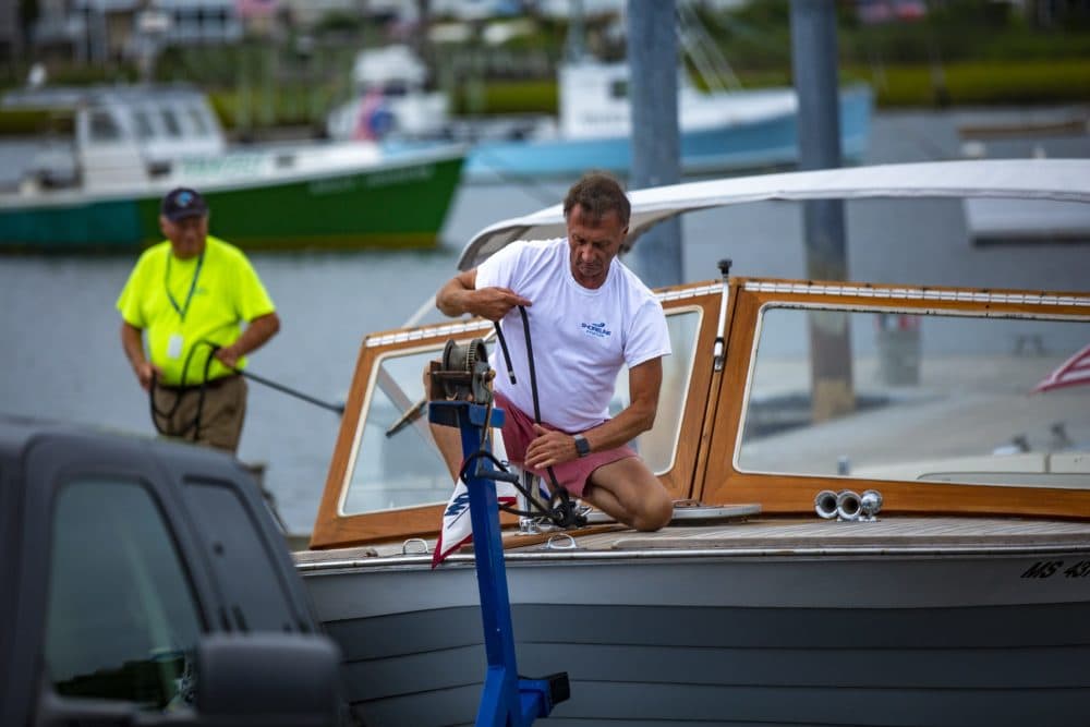 With Henri approaching, Keith Douglas works to remove his boat, Last Lisa, from Green Harbor in Marshfield. (Jesse Costa/WBUR)