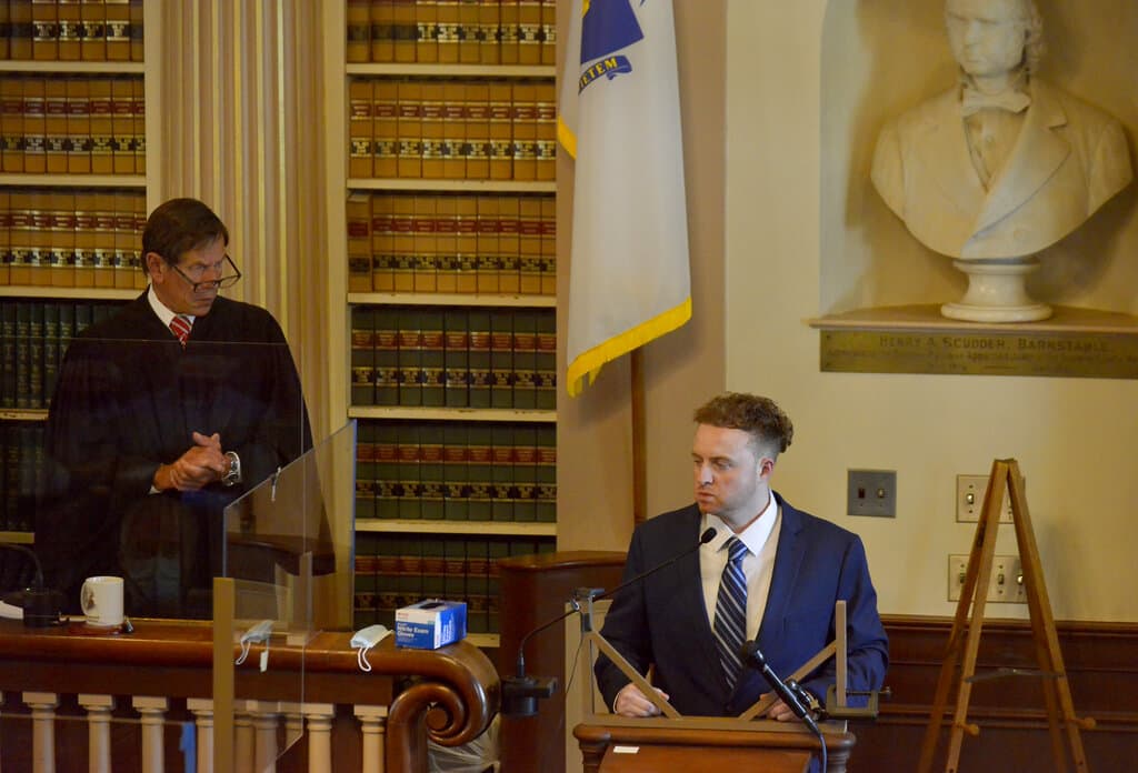 Superior Court Judge Jeffrey Locke, left, speaks to the jury during testimony by Thomas Latanowich, right, in Barnstable Superior Court in Barnstable, Mass., on Monday, Aug. 16, 2021. (Merrily Cassidy/Cape Cod Times via AP, Pool)