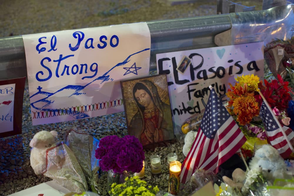 In this Aug. 4, 2019, a Virgin Mary painting, flags and flowers adorn a makeshift memorial for the victims of the mass shooting at a Walmart in El Paso, Texas. (Andres Leighton/AP)