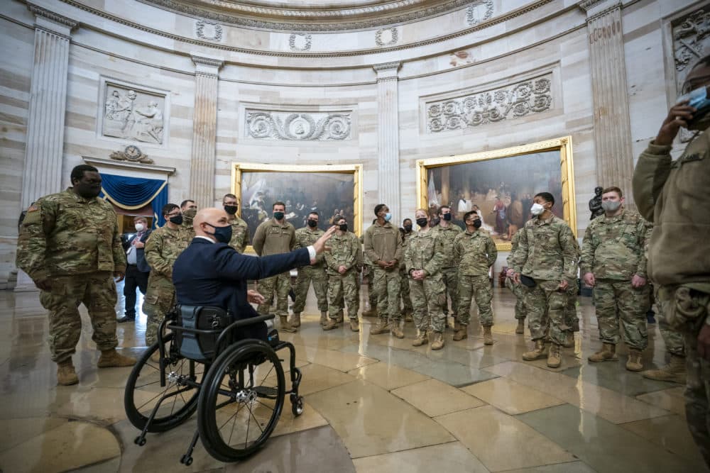 Rep. Brian Mast, R-Fla., left, visits with National Guard troops who are helping with security at the Capitol Rotunda in Washington, D.C., on Jan. 13, 2021. (J. Scott Applewhite/AP)