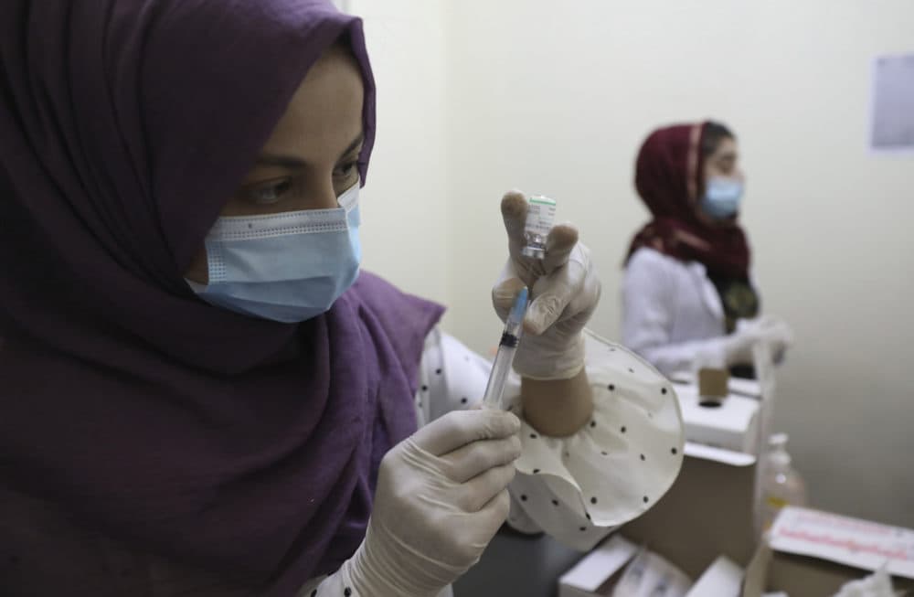 A doctor fills a syringe with the Sinopharm COVID-19 vaccine at a vaccination center in Kabul, Afghanistan, on June 16, 2021. (Rahmat Gul/AP)