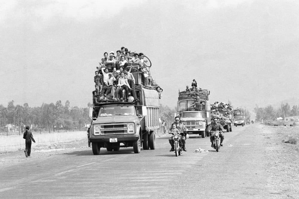Trucks and motorbikes, loaded with refugees, roar along the main highway from the old imperial capital of Hue to the port city of Danang about 50 miles south of Hue, March 25, 1975. (AP Photo)
