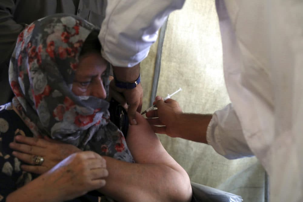 In this Sunday, July 11, 2021 file photo, a woman receives the Johnson & Johnson COVID-19 vaccine at a vaccination center in Kabul, Afghanistan, donated by the United States and delivered through the U.N.-backed COVAX program. (Rahmat Gul/AP)