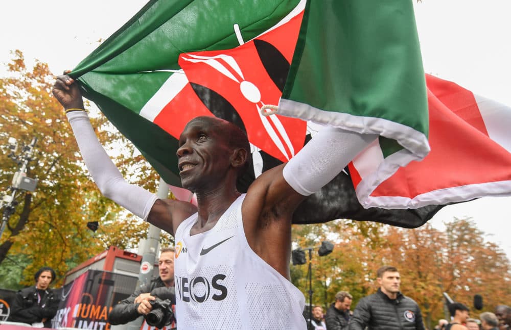 Eliud Kipchoge celebrates breaking the two hour barrier for a marathon distance with supporters and his team on the Hauptallee. (Thomas Lovelock for The INEOS 1:59 Challenge)