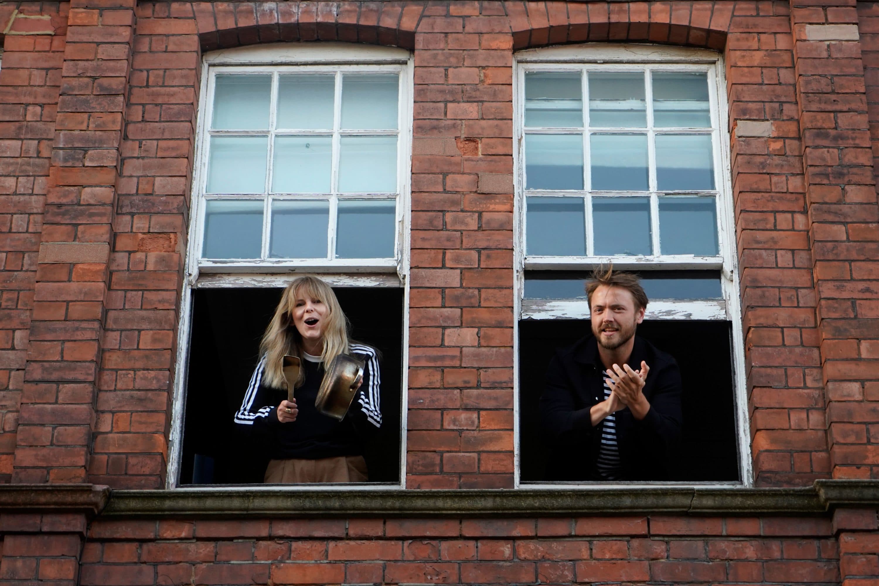 Residents take part in a "clap for carers" to show thanks for the work of Britain's NHS (National Health Service) workers and other frontline medical staff around the country as they battle with the novel coronavirus pandemic, outside her home in Streatham, south west London on May 28, 2020. (Niklas Halle'n/AFP via Getty Images)