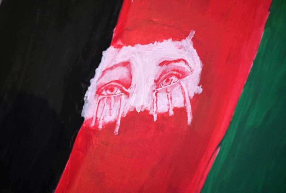 Tearful eyes are seen painted on a flag as members of the Los Angeles Afghan community and their supporters hold a vigil for Afghanistan outside the West LA Federal Building in Los Angeles, Aug. 17, 2021. (Robyn Beck/AFP/Getty Images)