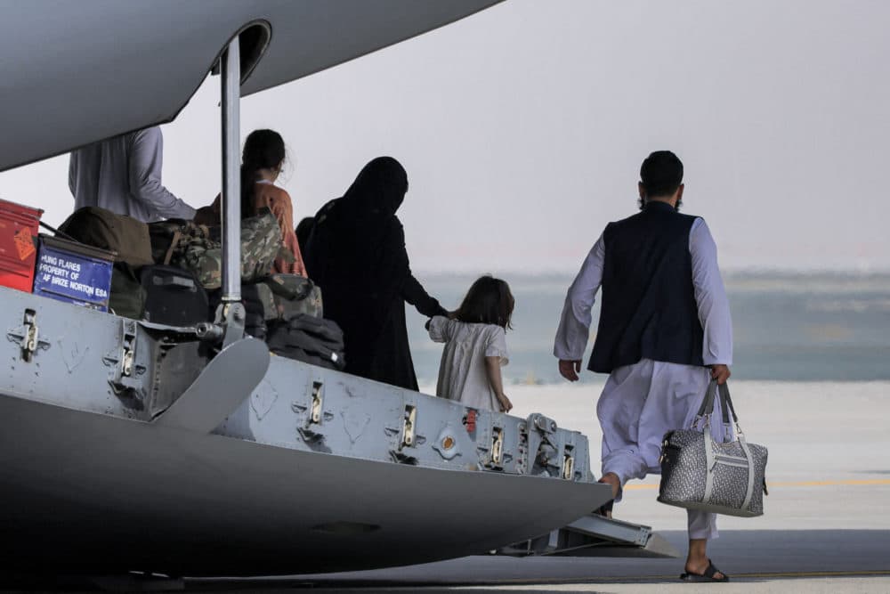 People disembark off a Royal Air Force military transport aircraft carrying evacuees from Afghanistan and arriving at Al-Maktoum International Airport in the United Arab Emirates on August 19, 2021. (Giuseppe Cacace/AFP via Getty Images)