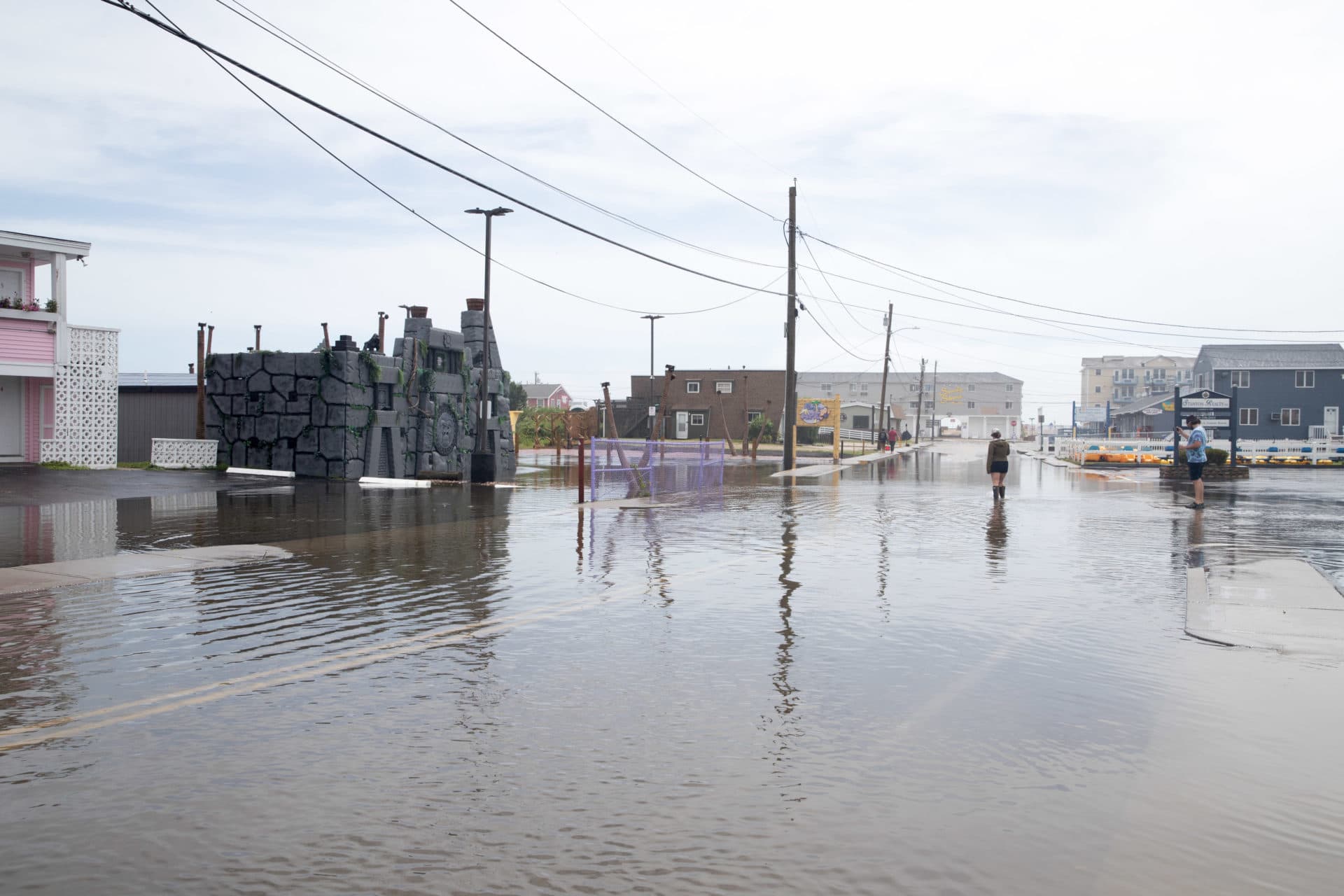 A person walks on a flooded road during Tropical Storm Henri in Westerly, Rhode Island. (Scott Eisen/Getty Images)
