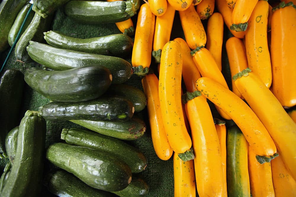 Zucchini is almost always dark green and grows fairly straight in shape, while yellow summer squash tends to be yellow and slightly bulbous on the bottom. They are very similar in taste and texture and can be used interchangeably. (Mario Tama/Getty Images)