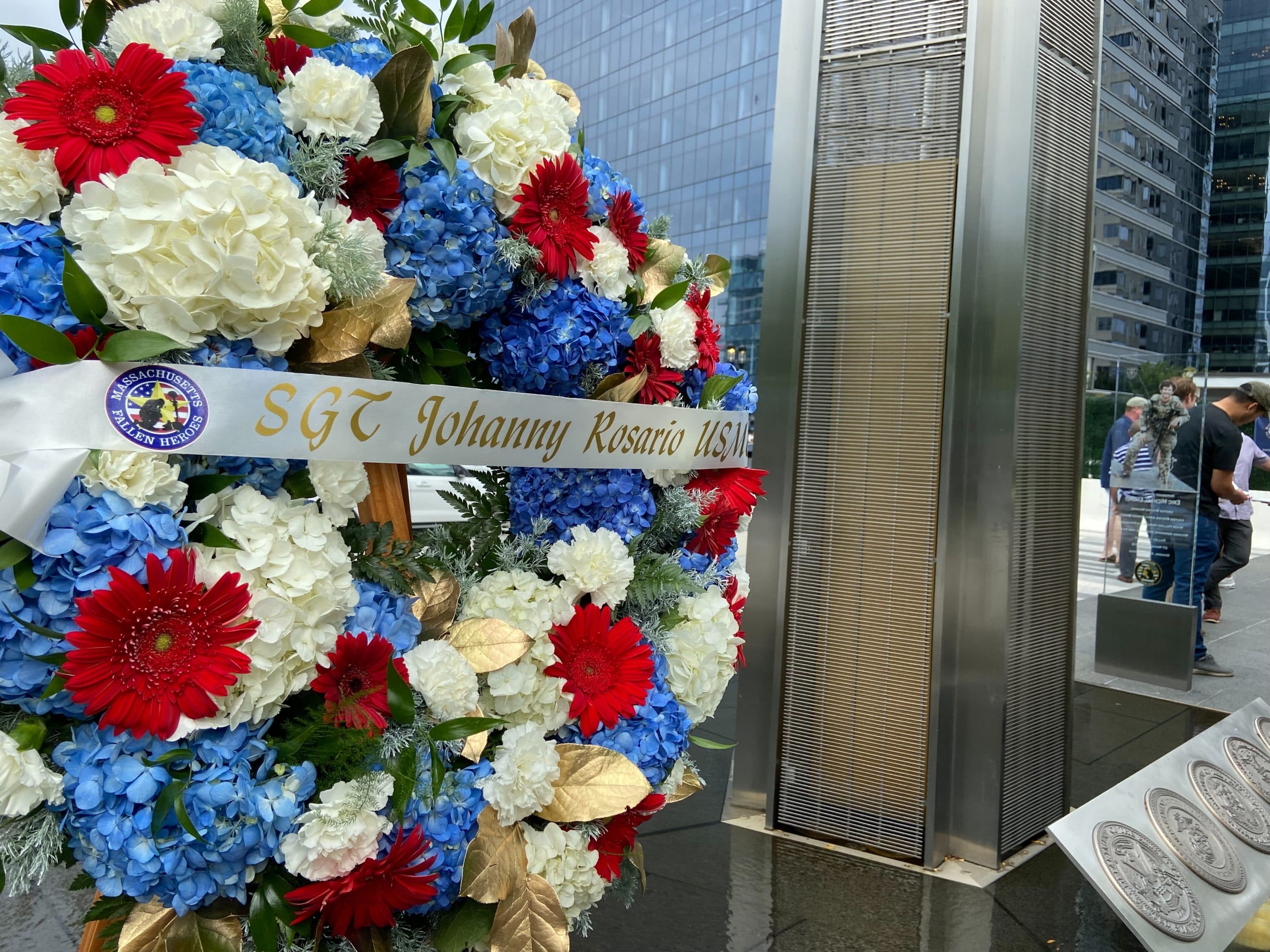 A wreath in honor of Marine Corps Sgt. Johanny Rosario who was one of 13 U.S. service members killed in the terrorist attack outside Kabul airport in Afghanistan. Two gold star members laid the wreath at the Massachusetts Fallen Heroes Memorial in the Boston Seaport District on Saturday. (Quincy Walters/WBUR)