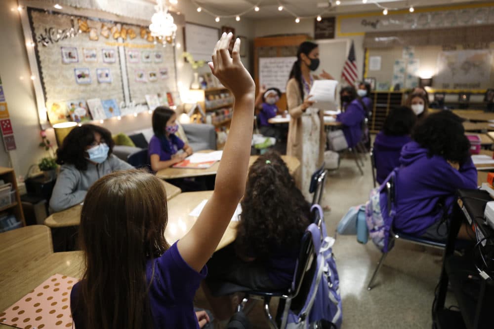 Students ask questions in the CORE History and English class of teacher Jessica Valera at the Girls Academic Leadership Academy: Dr. Michelle King School for STEM students in Los Angeles on the first day of in-class instruction on August 16. (Al Seib/Los Angeles Times via Getty Images)