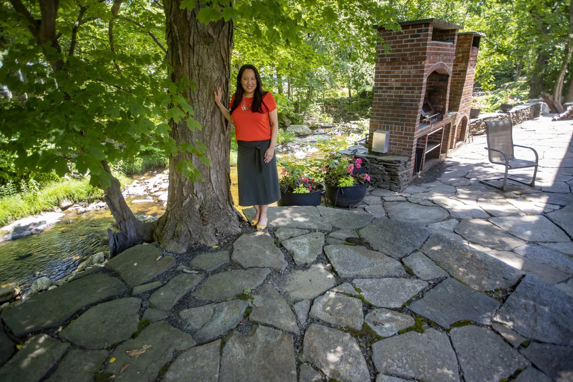Dr. Danielle Ignace stands beside a sugar maple tree in the backyard of her home in Williamsburg, Mass. (Jesse Costa/WBUR)