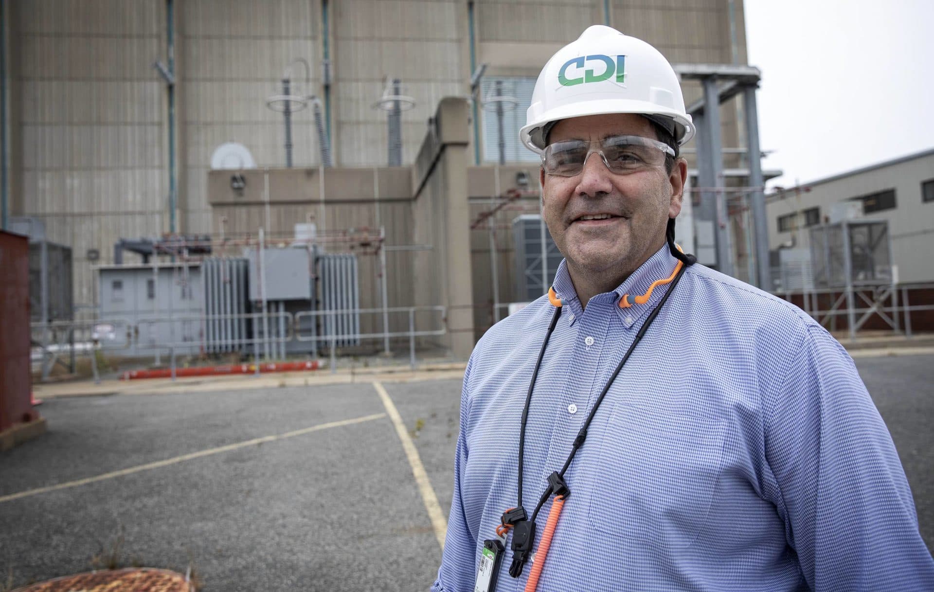 Decommissioning compliance manager Dave Noyes by the reactor building at the Pilgrim nuclear power plant. (Robin Lubbock/WBUR)