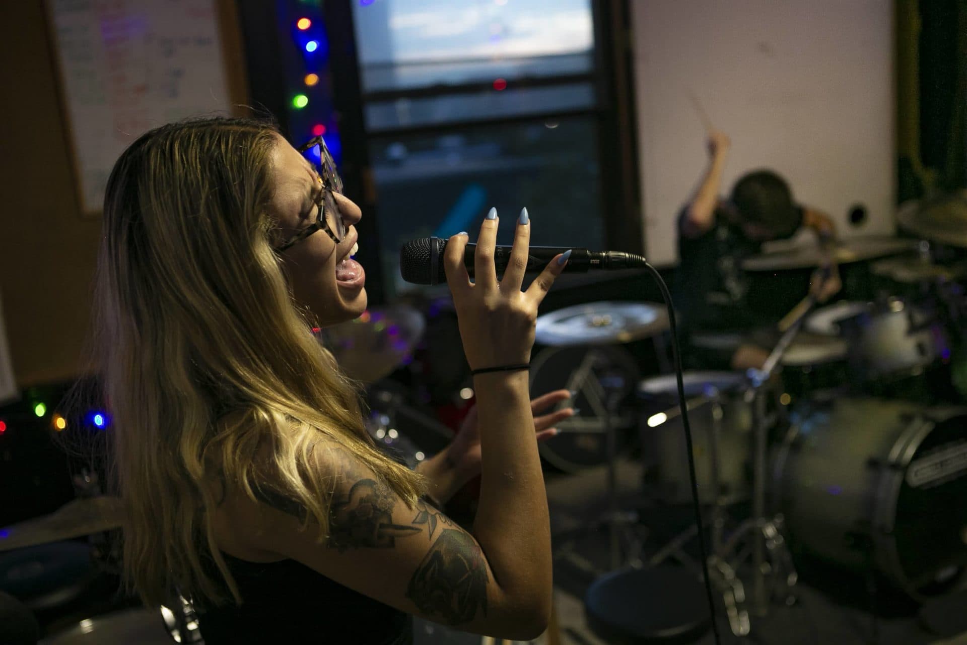 Singer Haydee Irizarry and drummer Dan DeLucia perform “Bogdweller” at the Carnivora practice space in Lynn. (Jesse Costa/WBUR)