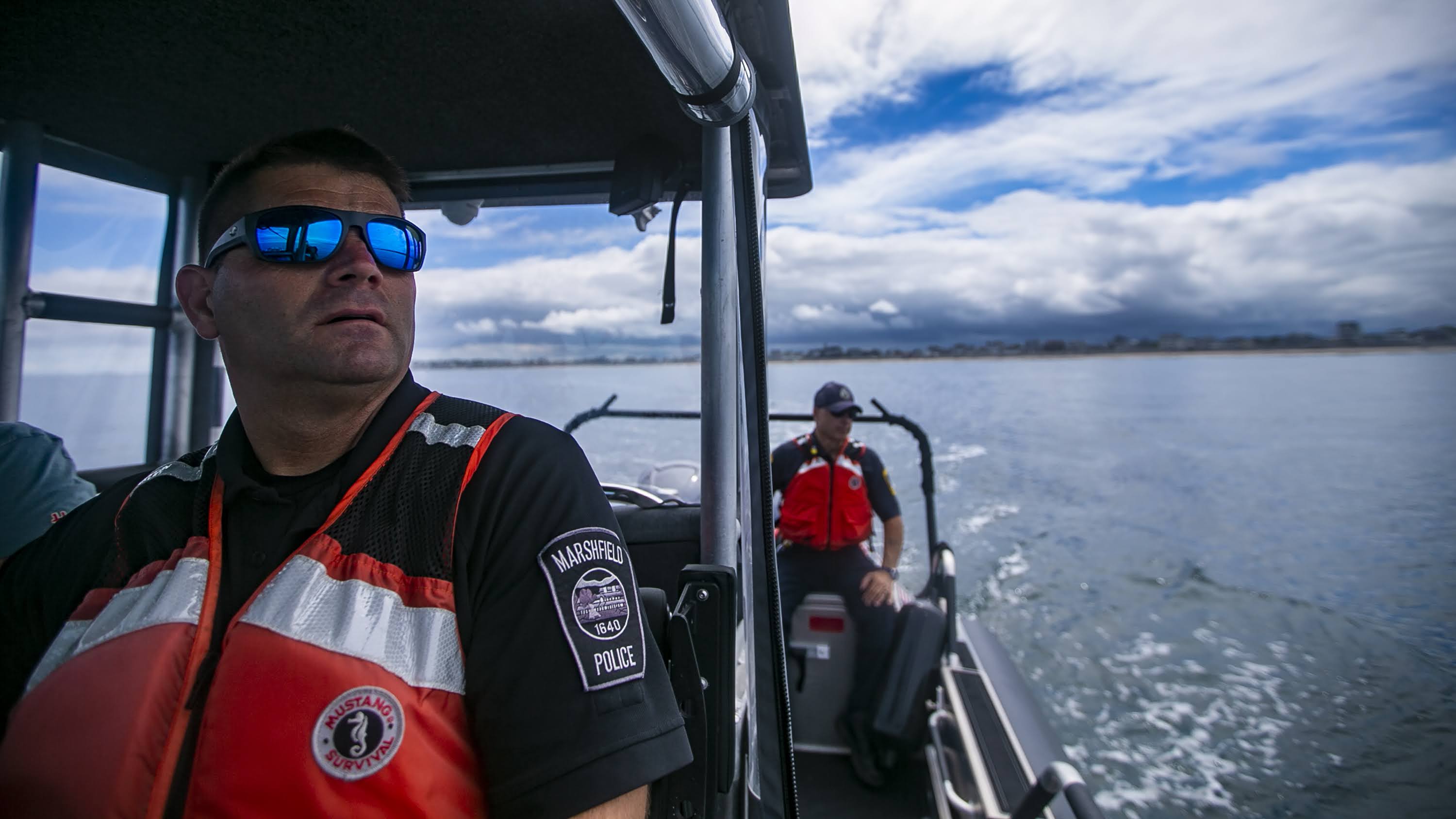 Marshfield Harbormaster Michael DiMeo and his assistant John Doyle patrol the area outside Green Harbor in Marshfield. (Jesse Costa/WBUR)