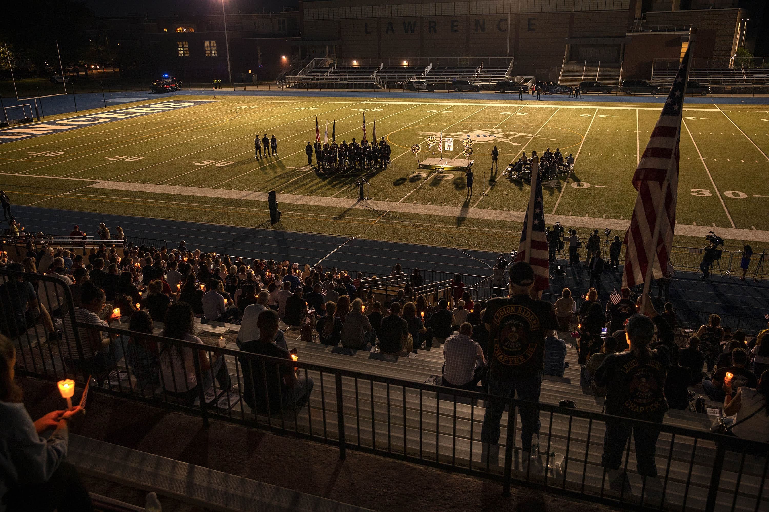 People gathered at the Veterans Memorial Stadium in Lawrence for the vigil. (Robin Lubbock/WBUR)