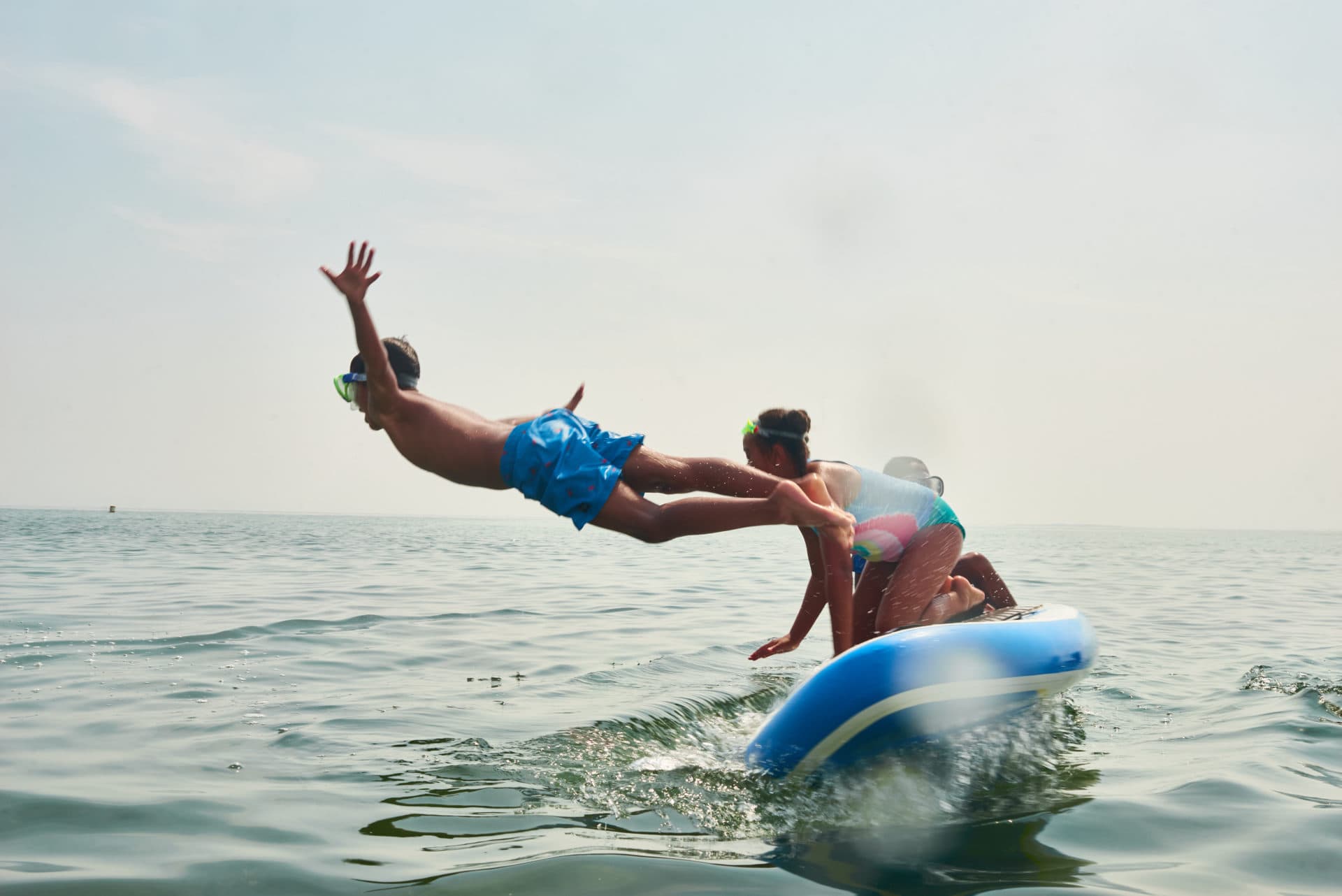 Drew Turner diving from a paddleboard in the waters off Inkwell Beach. (Courtesy Philip Keith)