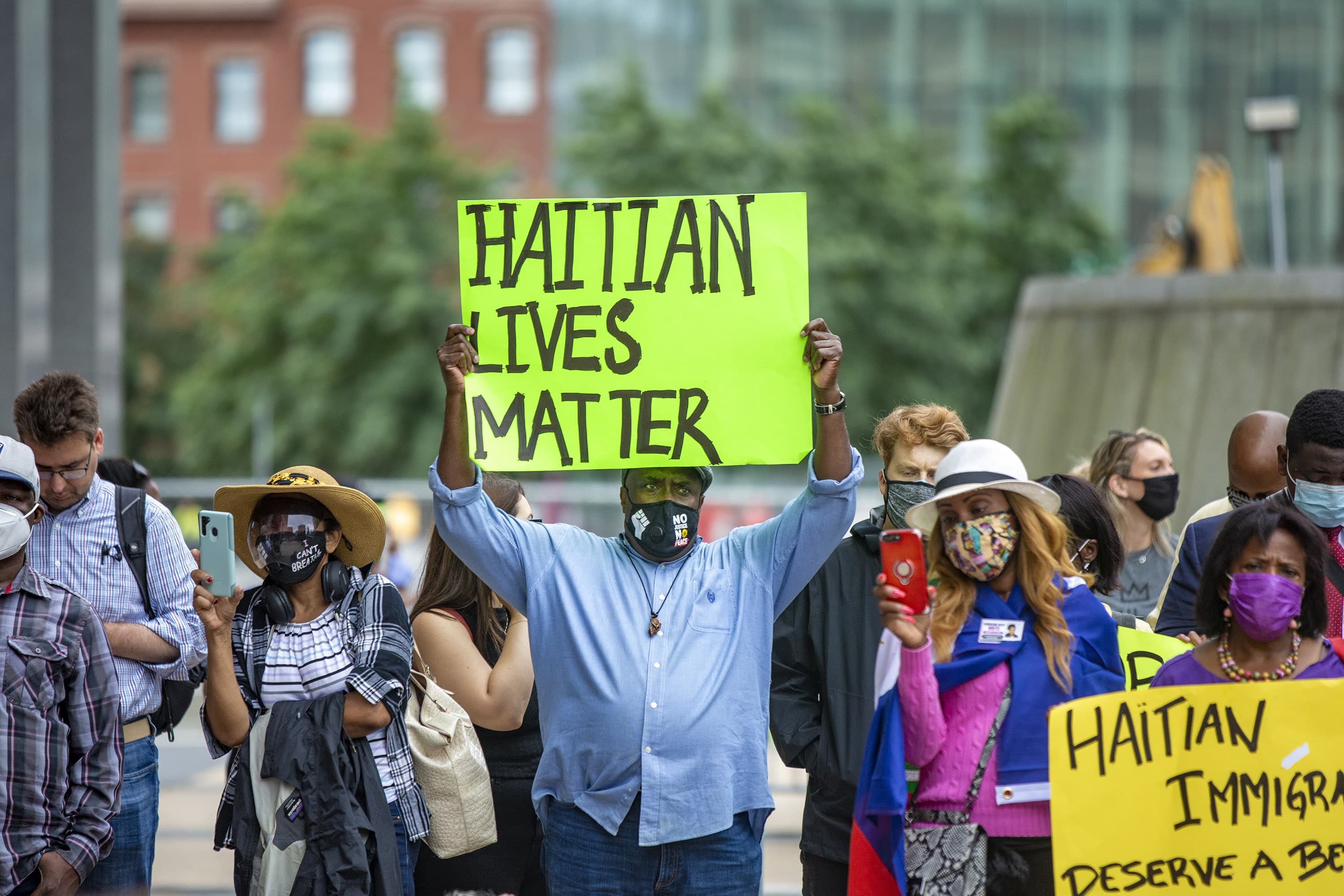 About 200 people gathered for the Solidarity with Haiti demonstration at John F. Kennedy Federal Building in Downtown Boston to protest the inhumane treatment of Haitian immigrants at the Texas border. (Jesse Costa/WBUR)