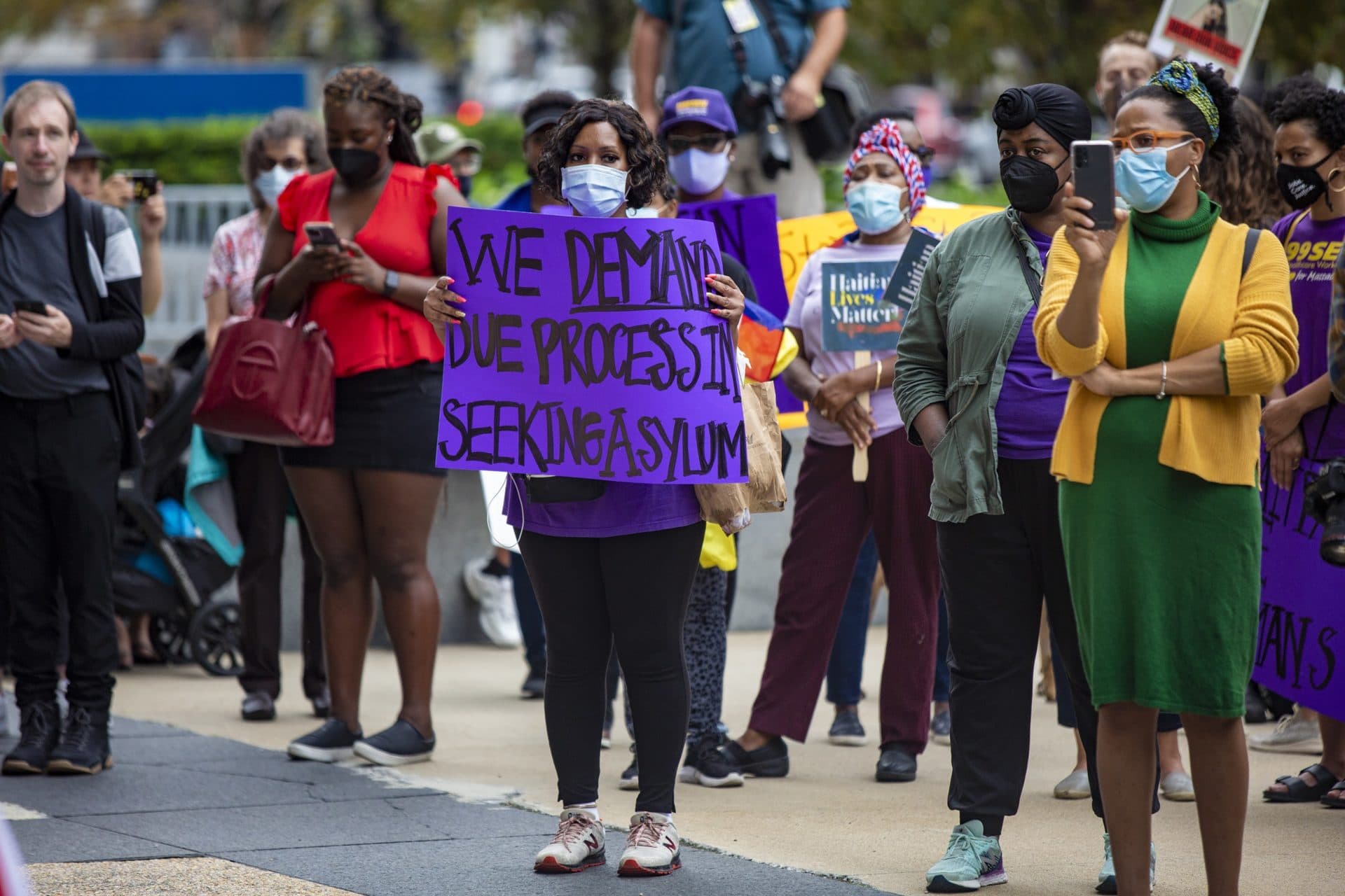 Hundreds gathered for the Solidarity with Haiti demonstration at John F. Kennedy Federal Building in Downtown Boston to protest the inhumane treatment of Haitian immigrants at the Texas border. (Jesse Costa/WBUR)