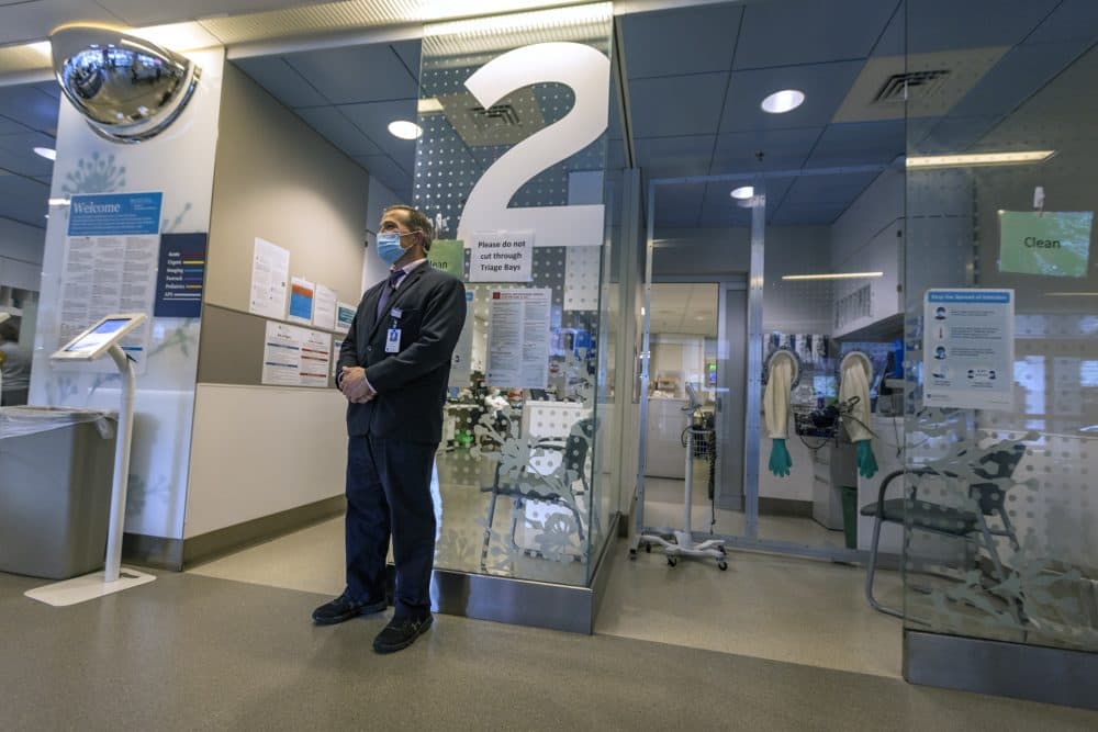 Security officer John Wood stands watch in the triage area of the emergency department at Massachusetts General Hospital. (Jesse Costa/WBUR)