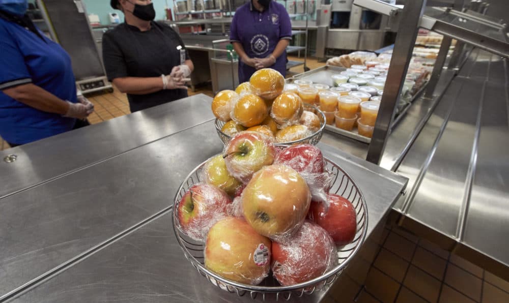 Individually wrapped apples and oranges and fruit in plastic cups are seen at the cafeteria line of the Norris Middle School in Omaha, Neb., on July 29, 2020. (Nati Harnik/AP)