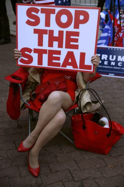 A demonstrator supporting former President Trump holds a sign that says, &quot;Stop the steal&quot; outside the Pennsylvania Convention Center where votes are being counted on Nov. 6, 2020, in Philadelphia. (Rebecca Blackwell/AP)