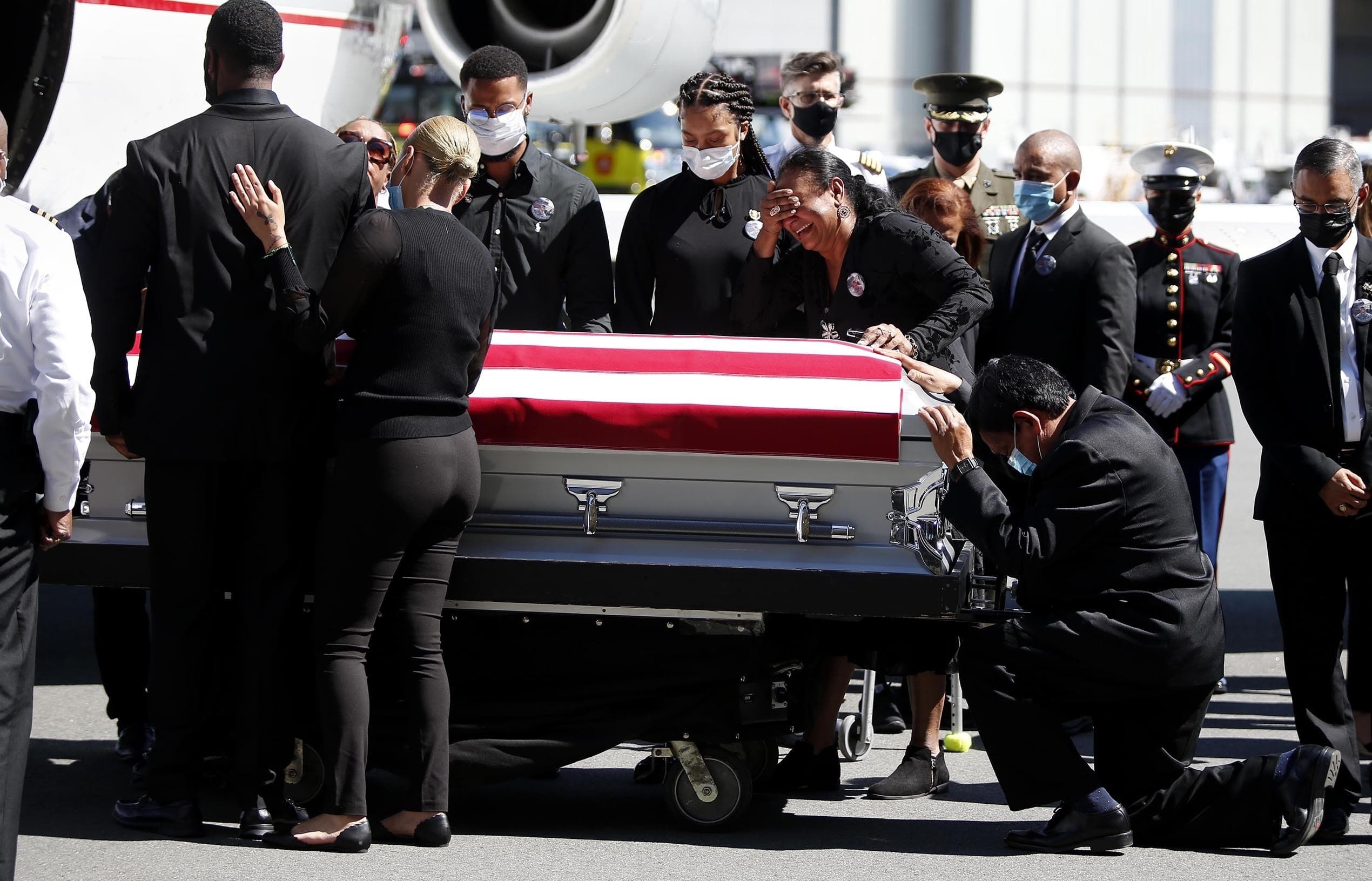 Family members of U.S. Marine Sgt. Johanny Rosario Pichardo are emotional as the casket with Pichardo arrives at Logan Airport on Saturday, Sept. 11, 2021. Pichardo died in the Aug. 26 suicide bombing near the Kabul airport where people were being evacuated amid the Taliban takeover of Afghanistan. (Jonathan Wiggs /The Boston Globe via AP, Pool)