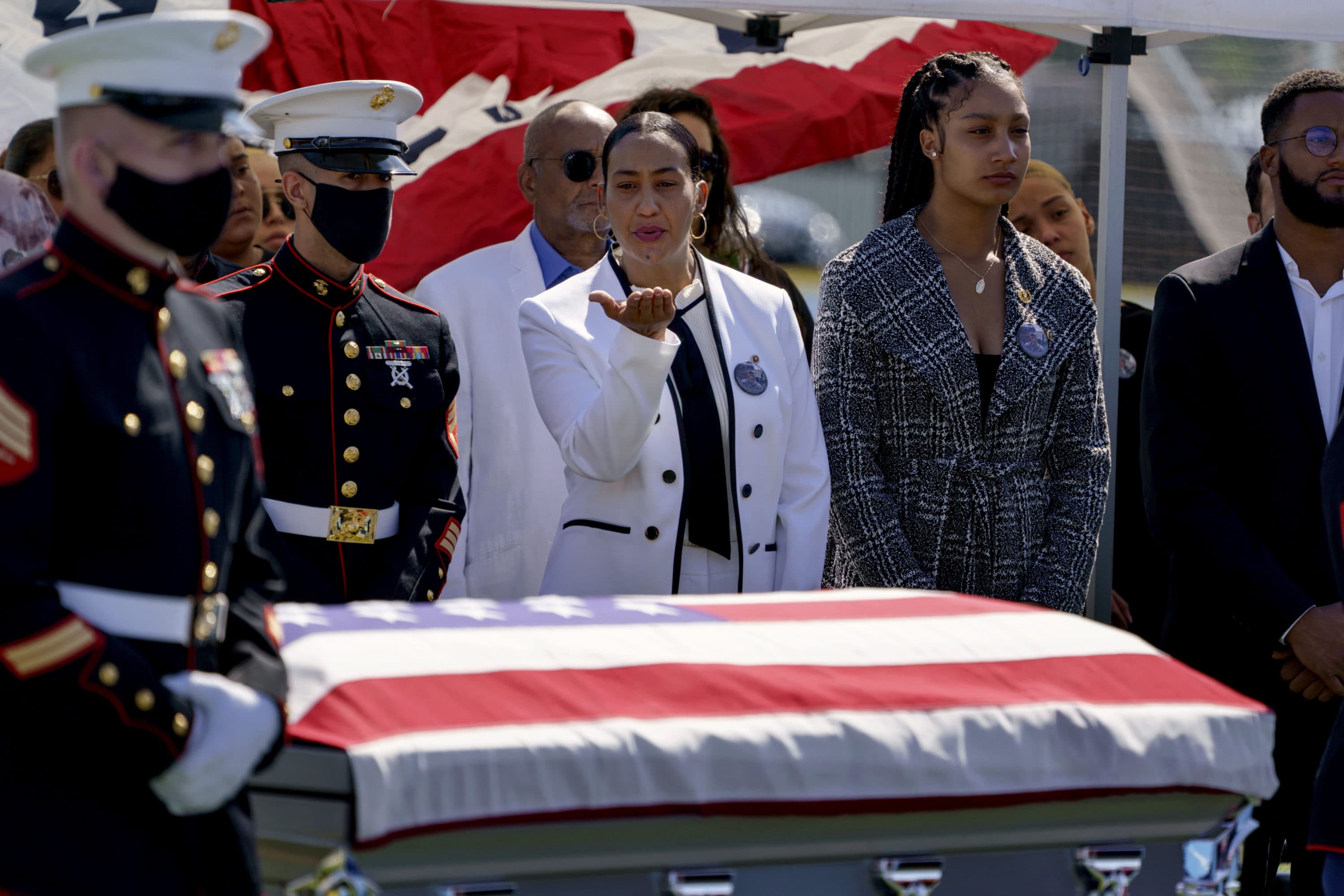 Colasa Pichardo, center, blows a kiss toward the casket of her daughter, Sgt. Johanny Rosario, a U.S. Marine who was among 13 service members killed in a suicide bombing in Afghanistan, during a public wake in her hometown of Lawrence on Tuesday. (David Goldman/AP)