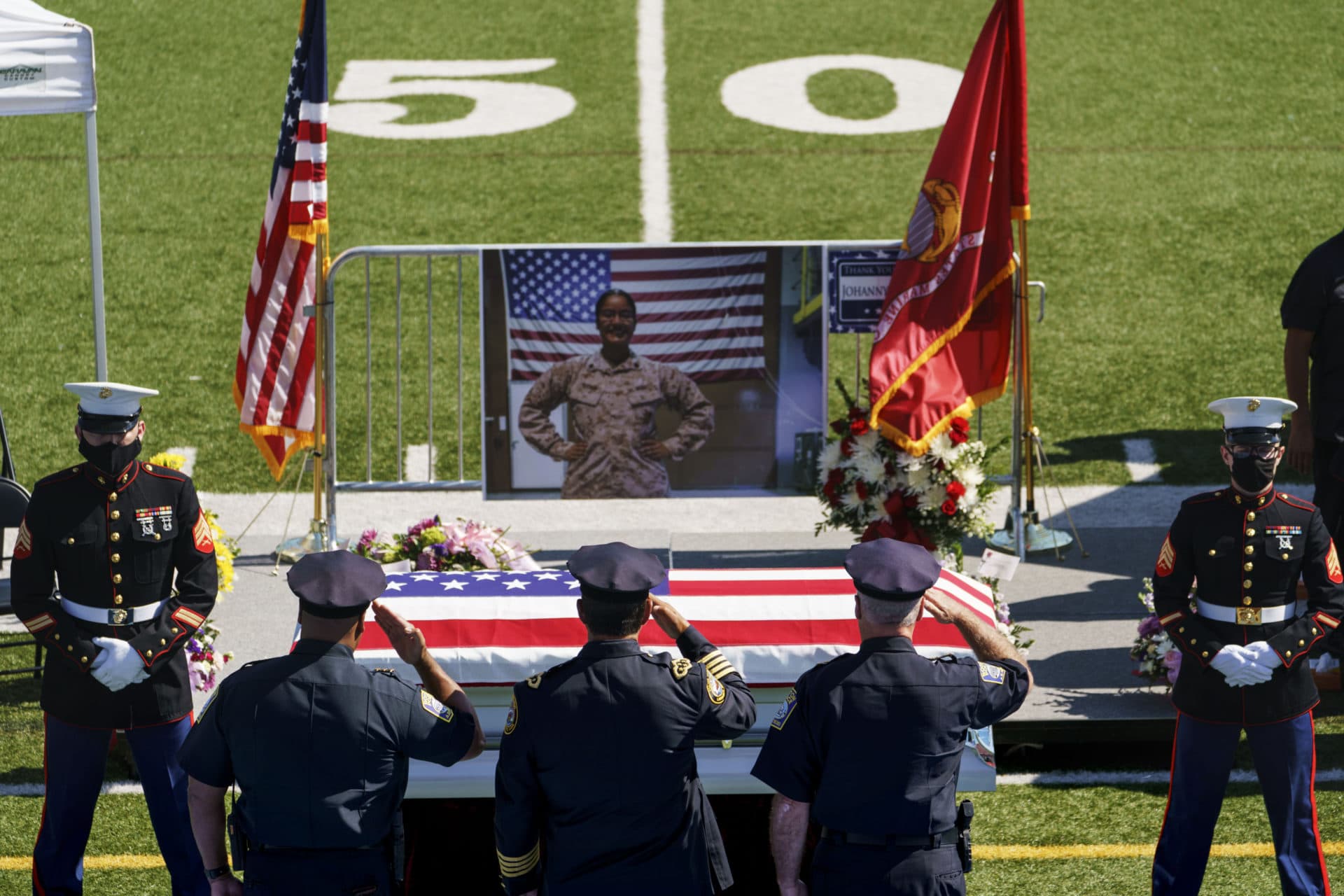 Law enforcement members salute the casket of Sgt. Johanny Rosario. (David Goldman/AP)