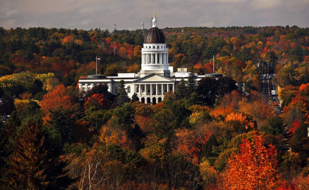 In this Oct. 23, 2017, file photo, the Maine State House is surrounded by fall foliage in Augusta. Recent leaf-peeping seasons have been disrupted by weather conditions in New England, New York and elsewhere. (Robert F. Bukaty/AP File)