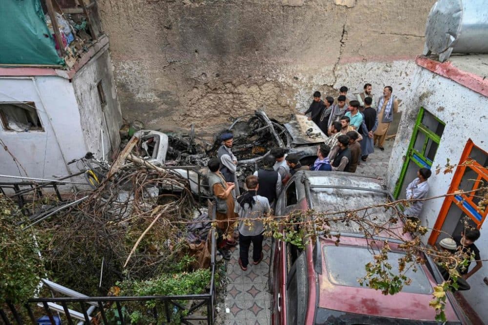 Afghan residents and family members of the victims gather next to a damaged vehicle inside a house, day after a U.S. drone airstrike in Kabul on Aug. 30, 2021. (Wakil Kohsar/Getty Images)