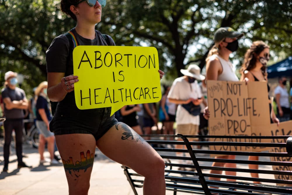 A woman carries a sign declaring abortion a part of healthcare at a rally at the Texas State Capitol on September 11, 2021 in Austin, Texas. Texas Lawmakers recently passed several pieces of conservative legislation, including SB8, which prohibits abortions in Texas after a fetal heartbeat is detected on an ultrasound, usually between the fifth and sixth weeks of pregnancy. (Jordan Vonderhaar/Getty Images)