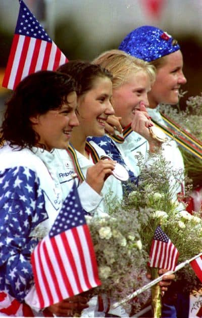 Olympic gold winning swimmers of the U.S. women's medley team (L-R): Lea Loveless, Anita Nall, Crissy Perham and Jenny Thompson acknowledge cheers during the medal ceremony in Barcelona on July 30, 1992. (Eric Feferberg/AFP via Getty Images)