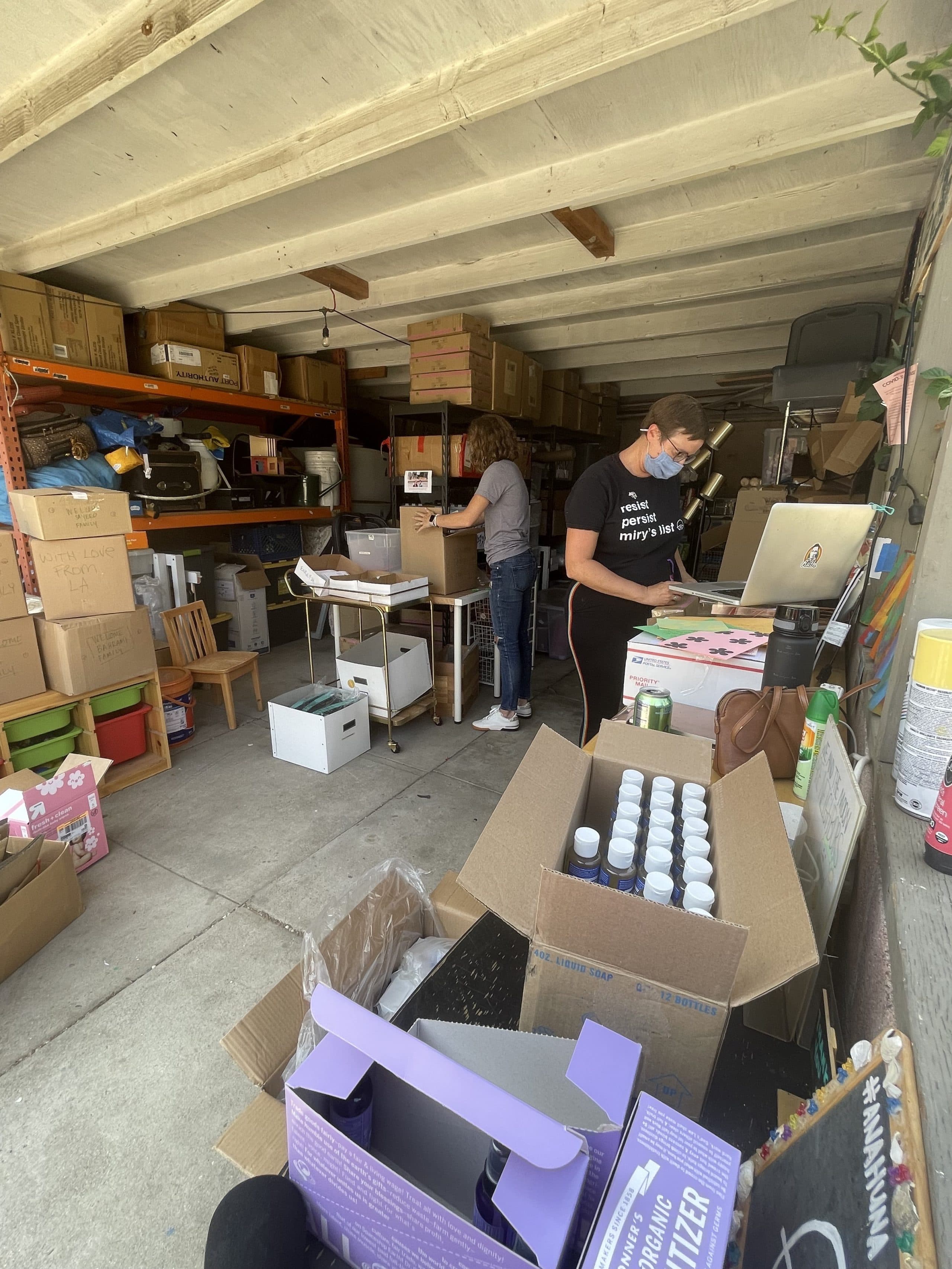 Miry's List founder Miry Whitehill and volunteer Krysta Masciale assemble care packages for new Afghan refugees arriving in the U.S. (Tonya Mosley/Here & Now)