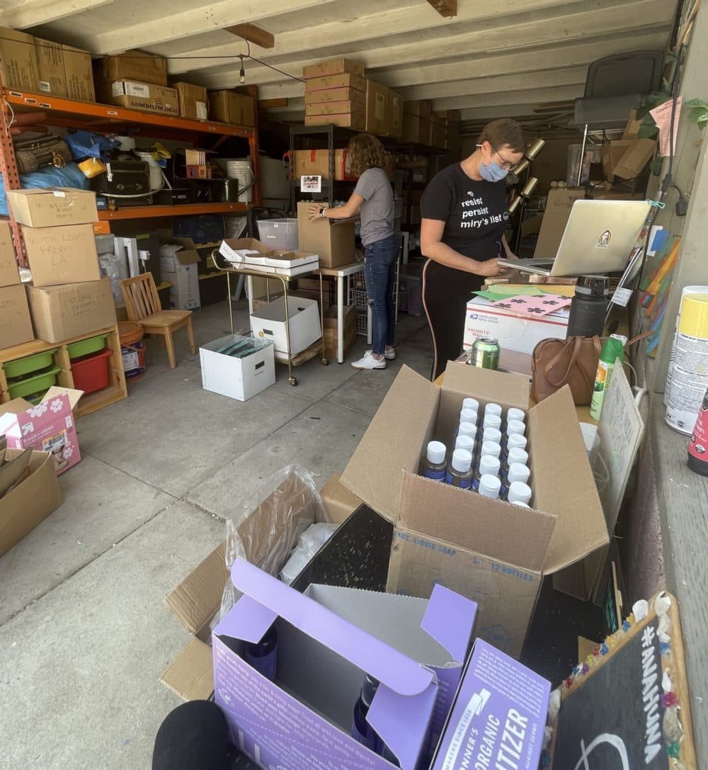 Miry's List founder Miry Whitehill and volunteer Krysta Masciale assemble care packages for new Afghan refugees arriving in the U.S. (Tonya Mosley/Here &amp; Now)