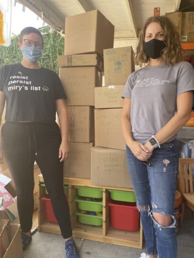 Miry's List founder Miry Whitehill and volunteer Krysta Masciale in front of the care packages they've assembled for new Afghan refugees arriving in the U.S. (Tonya Mosley/Here &amp; Now)