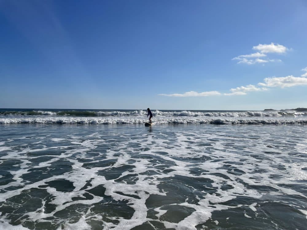 The author's daughter rides a wave to shore in August 2021. (Courtesy Sara Shukla) 