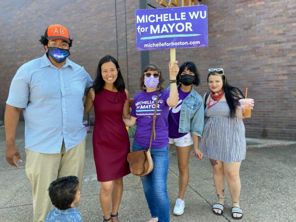 Boston mayoral candidate Michelle Wu (second from left) outside the Jackson Mann Community Center. (Quincy Walters/WBUR)
